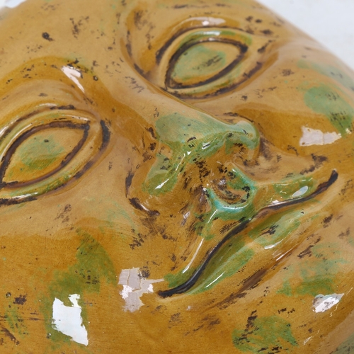 314 - A large yellow and green glaze plaster man in the moon wall sculpture, unsigned, diameter 30cm