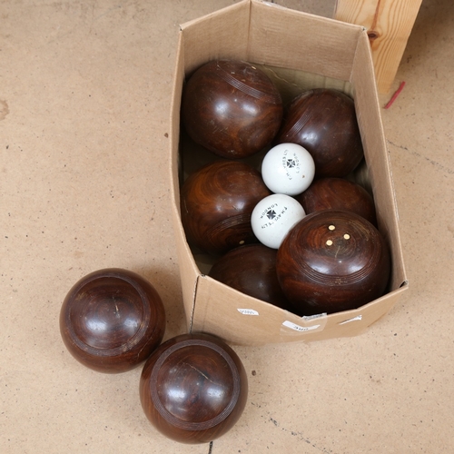 396 - A set of 8 lignum vitae lawn bowls, and 2 white ceramic jacks by F H Ayres Ltd of London