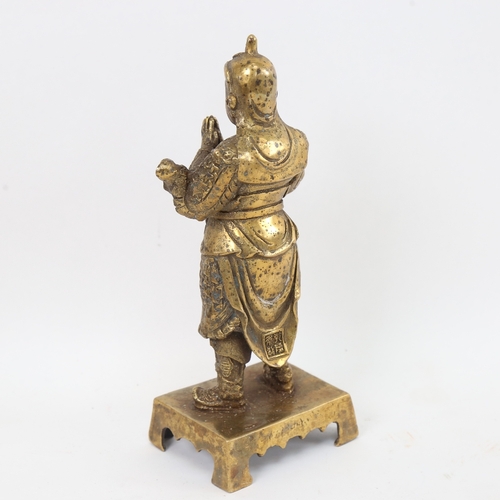 434 - A Chinese bronze praying deity figure, Zhuan Shu script 4 character mark, height 23cm