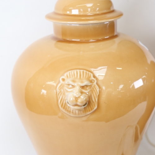 538 - A large pair of Oriental style caramel glaze baluster jar table lamps and shades, with lion mask han... 