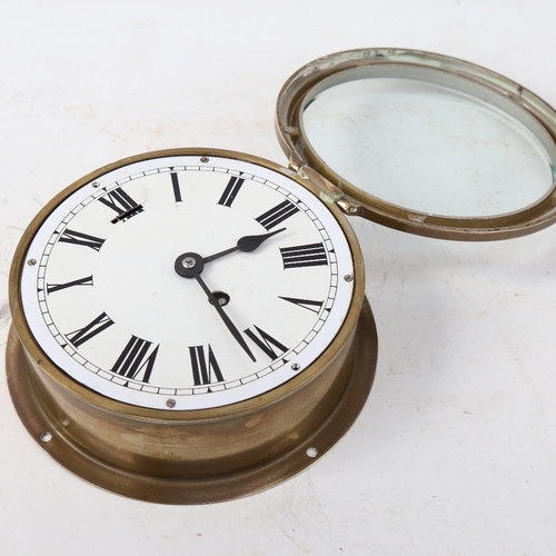 548 - A brass ship's bulkhead clock, white dial with Roman numeral hour markers, dial diameter 15.5cm