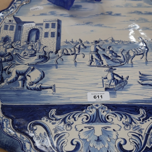 611 - A large Dutch Delft blue and white ceramic wall plaque, ice skating scene, 58cm x 48cm