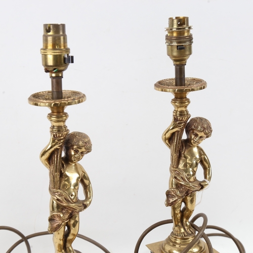 614 - A pair of polished cast-brass figural boy table candlesticks, on veined black marble bases, overall ... 