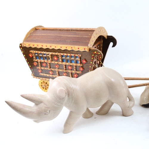 623 - A gypsy caravan and porcelain Shire horse, and a polished hardstone rhino, length 40cm