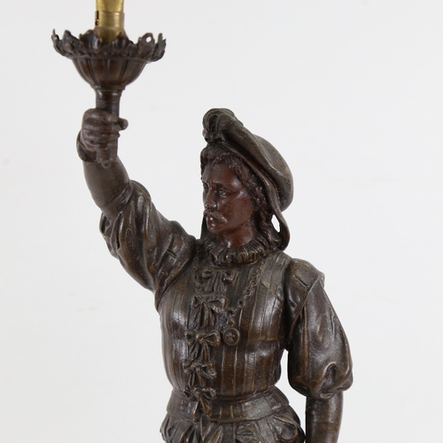 686 - A large bronzed spelter figural table lamp, rifleman holding a torch, height 57cm