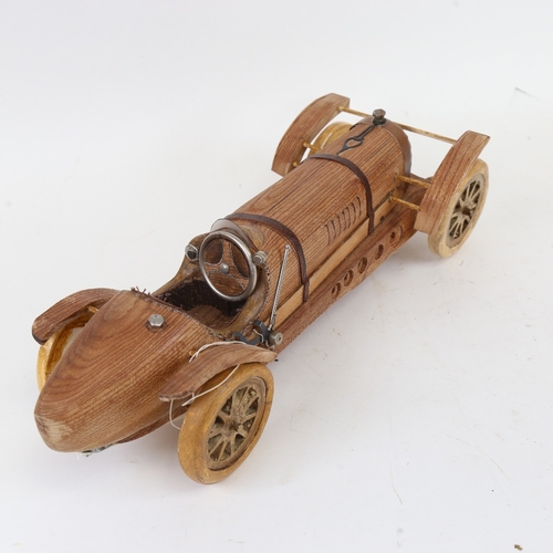 856 - A handmade carved wood model sculpture of a Veteran racing car, by Clive Fredriksson, length 39.5cm