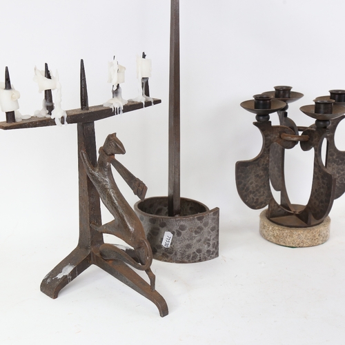 881 - A group of Arts and Crafts style planished and wrought-metal candlesticks, including figural cricket... 