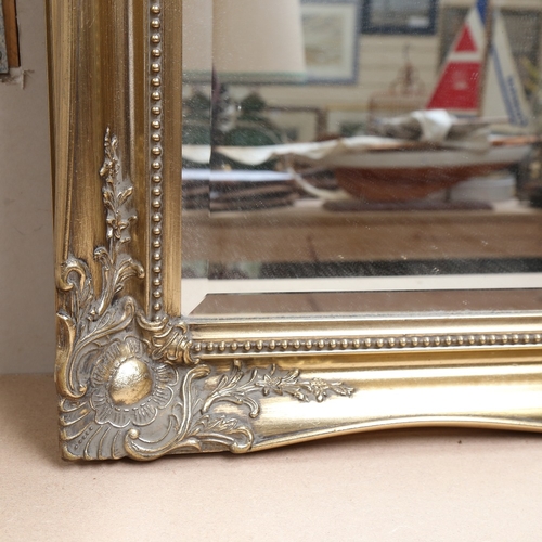 953 - A large rectangular gilt-framed bevel-edge wall mirror, overall 76cm x 106cm