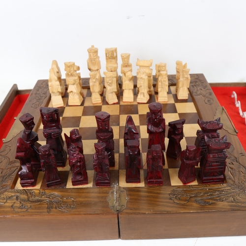 954 - An Oriental folding games box, with chess board and chessmen