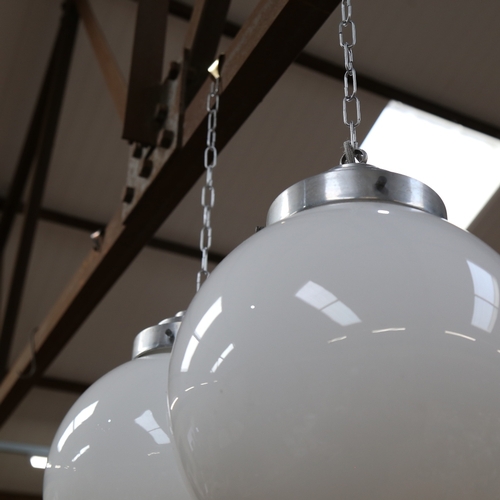 991 - A mid-century pair of milk glass globe and aluminium hanging ceiling lights, shade diameter approx 2... 