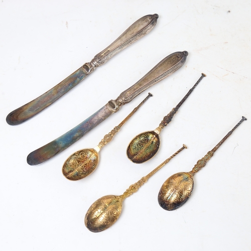 1218 - A cased set of 6 silver-gilt anointing spoons, and a set of 6 silver-handled butter knives