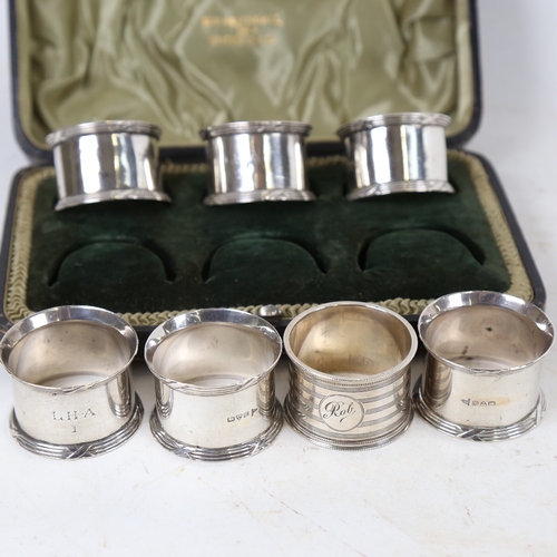 1325 - An Edwardian cased set of 6 silver napkin rings, by Walker & Hall, hallmarks Chester 1906, and anoth... 