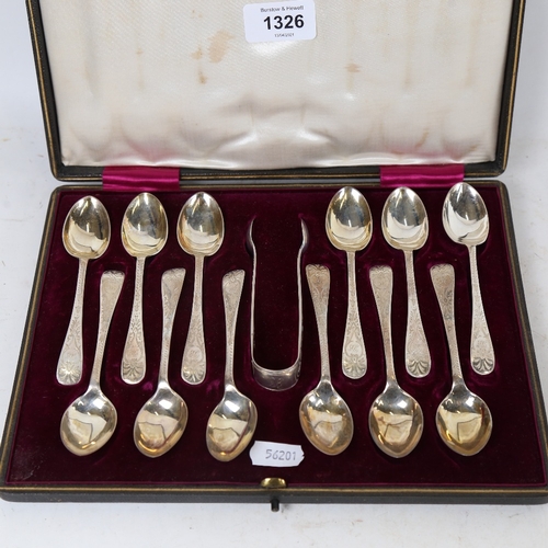 1326 - An Edwardian cased set of 12 matching silver teaspoons and a pair of sugar tongs, by W S Savage & Co... 