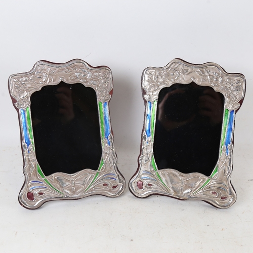 1328 - A pair of Art Nouveau style Continental silver and enamel-fronted strut photo frames, overall height... 