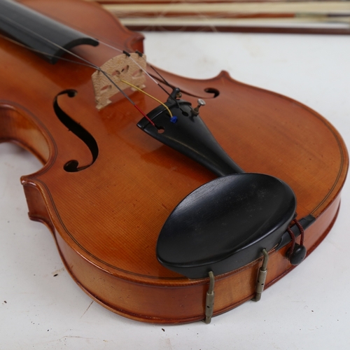 891 - A 20th century violin, and a viola, with 3 bows, in double instrument hardshell case