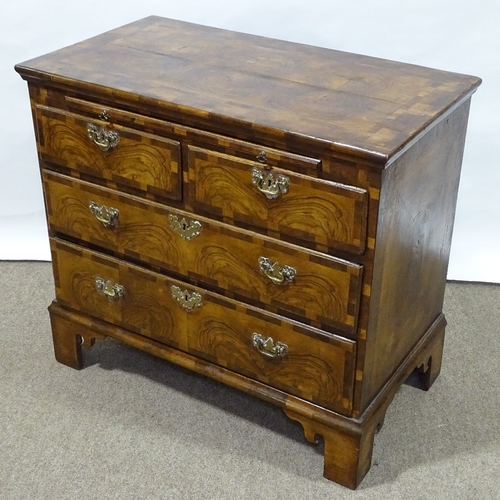 180 - An 18th century figured walnut bachelor's chest of drawers, with brushing slide, ornate multi-panel ... 