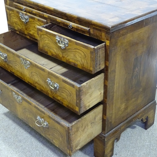 180 - An 18th century figured walnut bachelor's chest of drawers, with brushing slide, ornate multi-panel ... 