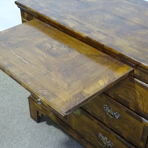 180 - An 18th century figured walnut bachelor's chest of drawers, with brushing slide, ornate multi-panel ... 