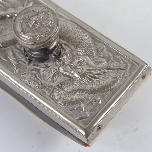 191 - A Chinese nickel-plate desk blotter, circa 1900, with relief dragon design, length 13.5cm