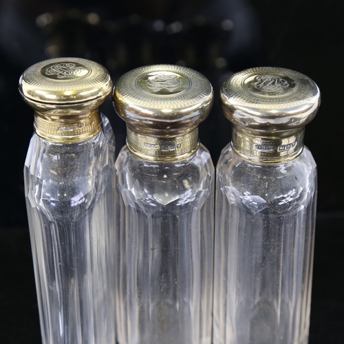 243 - A set of 3 Asprey's cut-glass and silver-gilt topped perfume bottles, hallmarks London 1910, largest... 