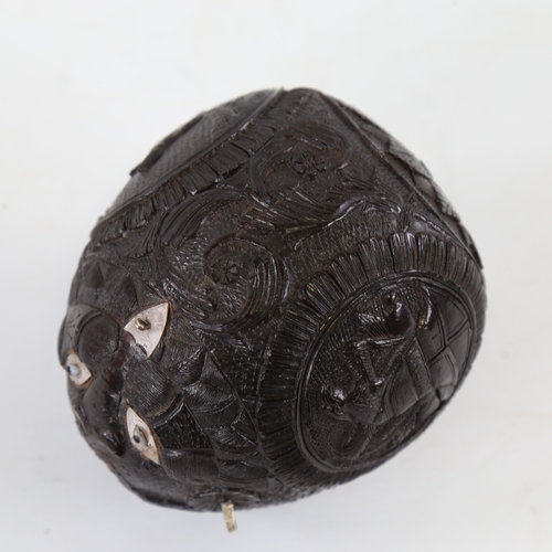 108 - 19th century Napoleonic coconut flask, relief carved allover with military insignia, length 10.5cm