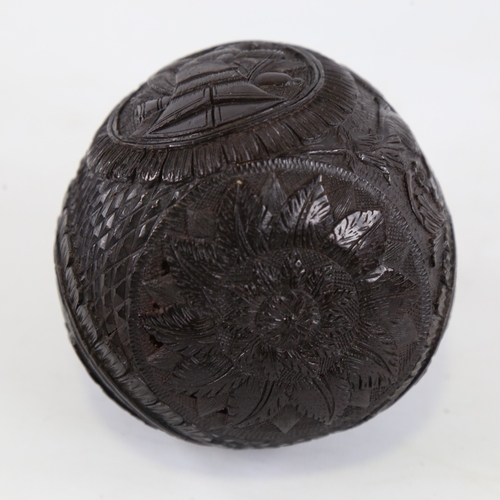 108 - 19th century Napoleonic coconut flask, relief carved allover with military insignia, length 10.5cm