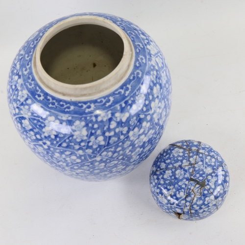 123 - A Chinese blue and white porcelain jar and cover, hand painted blossom decoration with painted marks... 