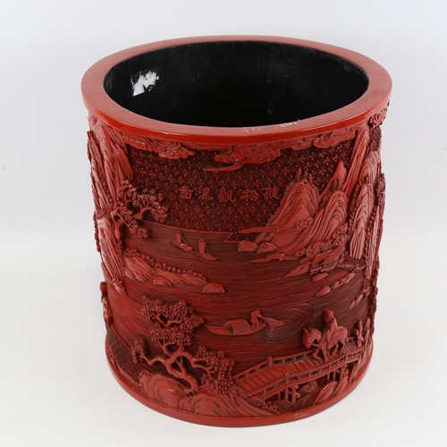 124 - A large Chinese cinnabar lacquer pot of cylindrical form, relief moulded mountain landscape designs,... 