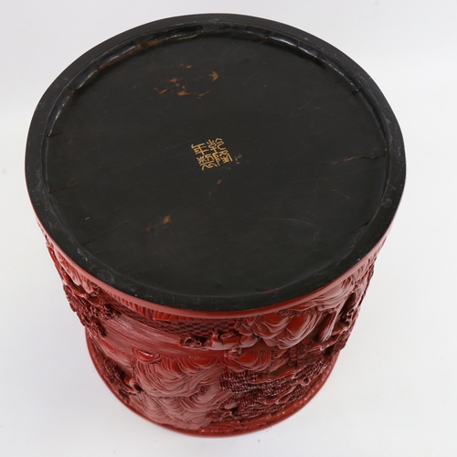 124 - A large Chinese cinnabar lacquer pot of cylindrical form, relief moulded mountain landscape designs,... 