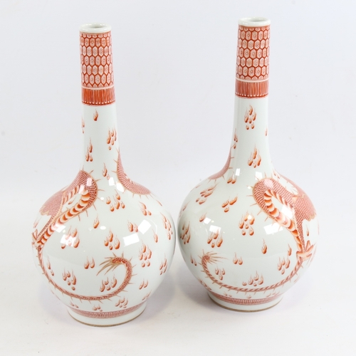 151 - A pair of Chinese white glaze porcelain bottle vases, with hand painted iron red and gilt dragons an... 
