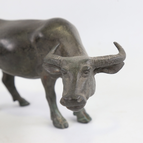 152 - A Chinese patinated bronze water buffalo, length 23cm, height 13cm