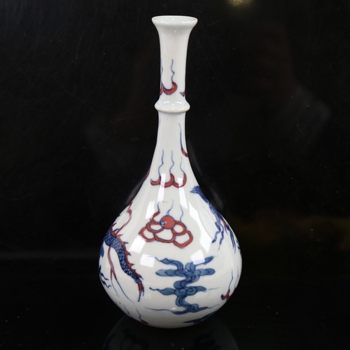 156 - A small Chinese white glaze porcelain bottle vase, hand painted blue and iron red dragon and pearl d... 