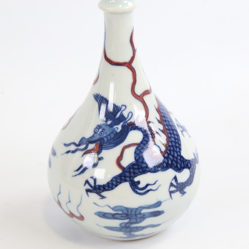 156 - A small Chinese white glaze porcelain bottle vase, hand painted blue and iron red dragon and pearl d... 