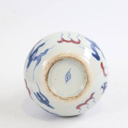 156 - A small Chinese white glaze porcelain bottle vase, hand painted blue and iron red dragon and pearl d... 