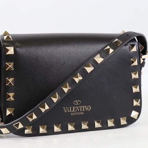 171 - VALENTINO - a small black leather and steel studded handbag with strap, length 15.5cm, with dustbag