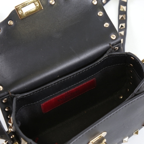 171 - VALENTINO - a small black leather and steel studded handbag with strap, length 15.5cm, with dustbag