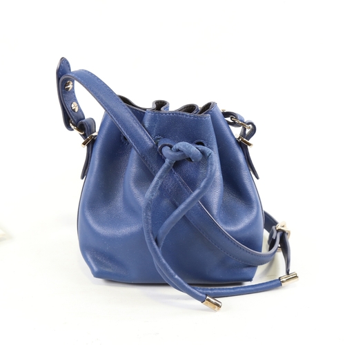 172 - PROENZA - a small dark blue leather handbag with shoulder strap and dust bag, height 15cm