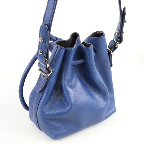 172 - PROENZA - a small dark blue leather handbag with shoulder strap and dust bag, height 15cm