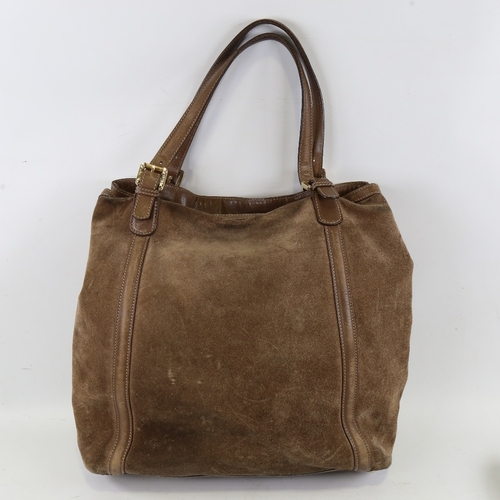 173 - GUCCI - a brown suede and leather shoulder bag with gilt monogram badge, length approx 40cm, height ... 