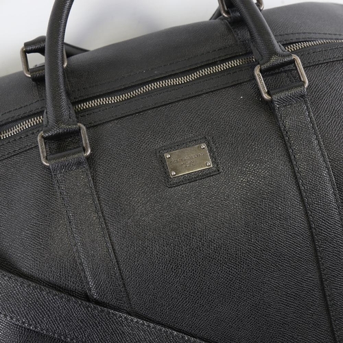 177 - DOLCE & GABBANA - a black leather holdall with shoulder strap, length approx 50cm