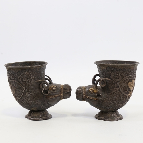 27 - A pair of 19th century Indian or Middle Eastern unmarked silver ceremonial cups of cornucopia form w... 