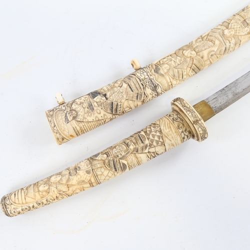 91 - A Japanese bone short sword, Meiji Period late 19th/early 20th century, relief carved figures all ov... 