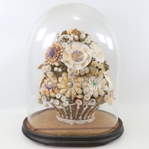 435 - A 19th century floral shell display under glass dome, overall height 42cm