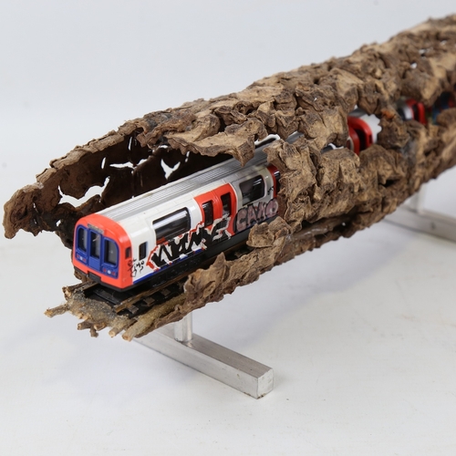 2202 - Chris Watson, graffitied tube train in log, mixed media wood/metal/paint, length 14