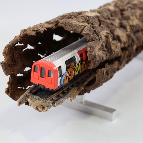 2202 - Chris Watson, graffitied tube train in log, mixed media wood/metal/paint, length 14