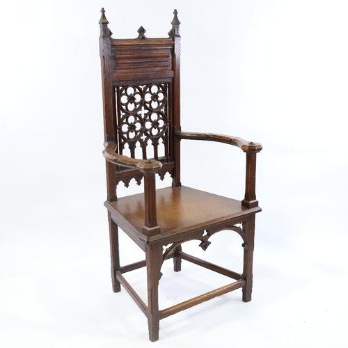 184 - A Victorian Gothic hall chair, carved and pierced Gothic tracery panelled back and curved arms, seat... 