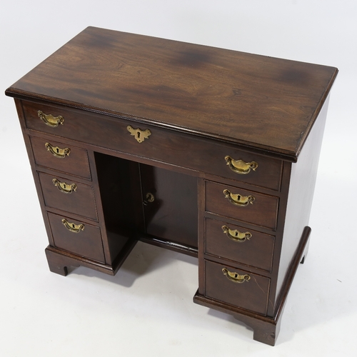 186 - A George III mahogany kneehole writing desk of small size, with alcove cupboard and drawers, 81cm x ... 