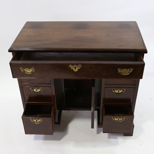 186 - A George III mahogany kneehole writing desk of small size, with alcove cupboard and drawers, 81cm x ... 