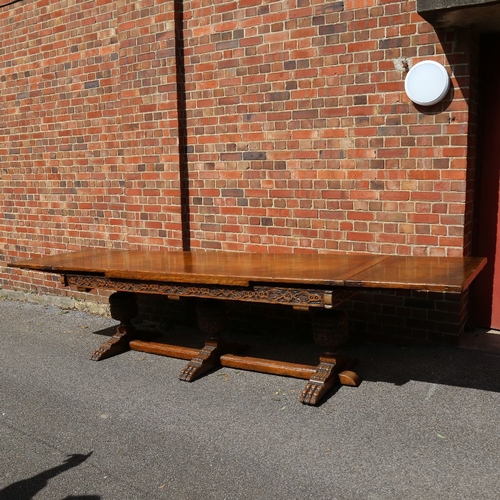 188 - A large Maple & Co oak extending refectory dining table, with relief carved geometric frieze, raised... 