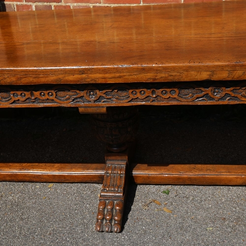 188 - A large Maple & Co oak extending refectory dining table, with relief carved geometric frieze, raised... 